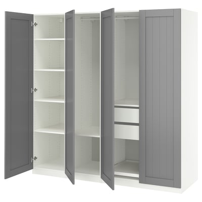 Grey PAX wardrobe with open doors revealing white shelves and drawers.