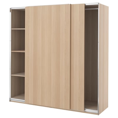 A light-colored wooden PAX wardrobe with sliding doors and three visible shelves.