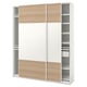 This image an IKEA PAX wardrobe in white with light wood accents. It has sliding doors and multiple shelves for storage.