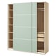 PAX wardrobe with light green sliding doors. Tall, rectangular shape with wooden shelves and drawers.