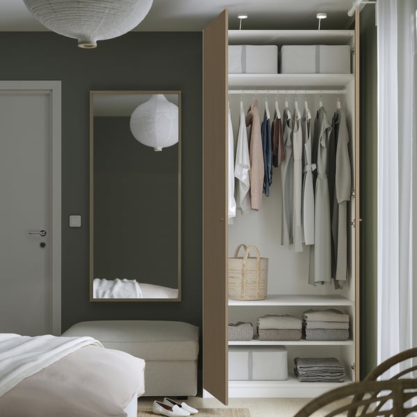 Modern PAX wardrobe with open door, clothes, and storage boxes.