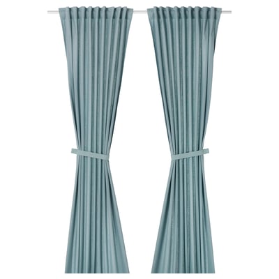 Two light grey-blue RITVA curtains, made of cotton, hanging straight with tie-backs.