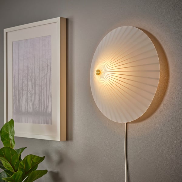 Modern wall lamp with a parasol-shaped opal glass shade provides soft, diffused light.