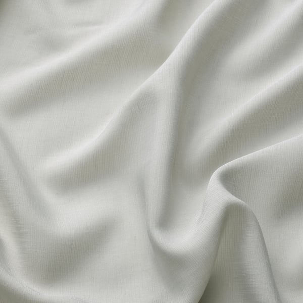 Close-up of soft, light grey sheer curtain fabric. Smooth texture, delicate weave, and gentle folds suggest high quality and elegant design.