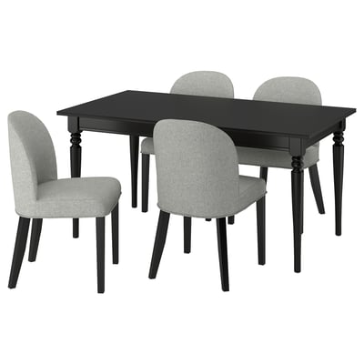 Modern black rectangular dining table with four grey cushioned chairs.