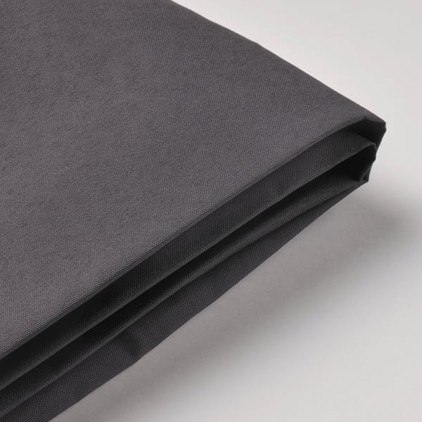 Folded black outdoor canopy on light surface. Premium, uv-resistant fabric with durable stitching.