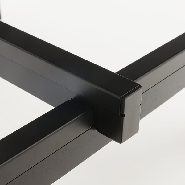 Modern black metal frame corner detail, showcasing sleek design and sturdy construction.
