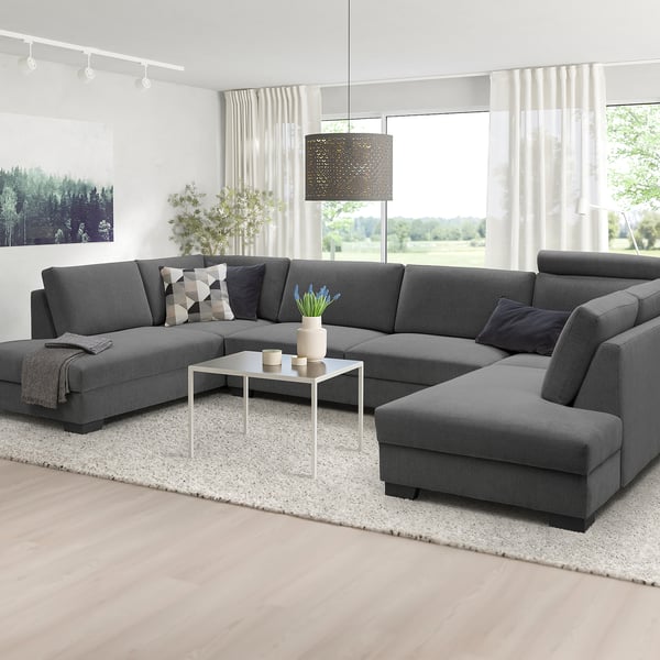 Modern grey u-shaped SÖRVALLEN sofa set, minimalist design, large size, with cushions and rug, positioned near big window.
