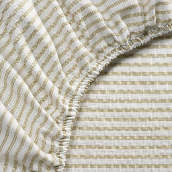 Beige and white striped bed sheet with ruffled edges, showcasing quality cotton texture and stitching.