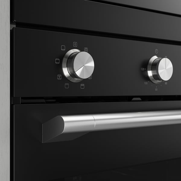 Modern black oven with stainless steel knobs and handle; sleek design, high-quality finish.