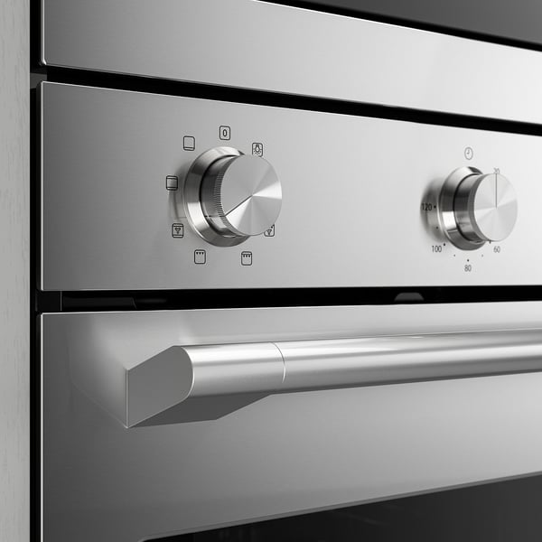 Stainless steel oven controls: sleek knobs, precise settings, modern design.