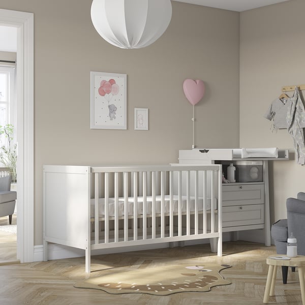 Cosy nursery with SUNDVIK crib, changing table, and decor.