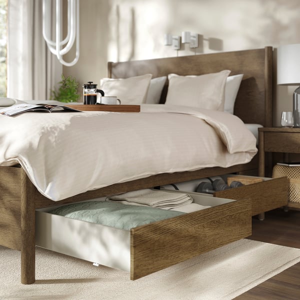 Modern bed with wooden frame, under-bed storage, classic design in bright, neutral bedroom.