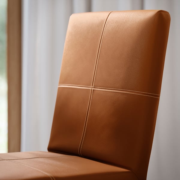 Close-up of high-quality, upholstered chair back with detailed stitching.