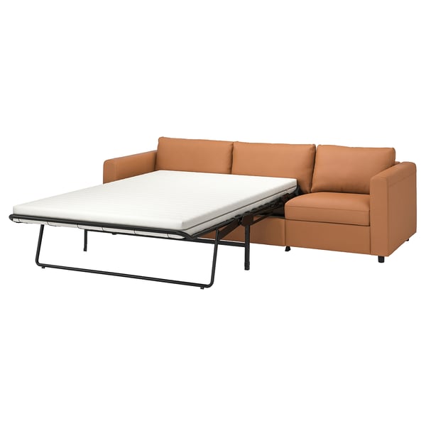 Tan VIMLE sofa-bed with cushions, clean design, convertible for guests.