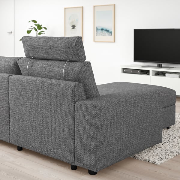 Grey VIMLE sectional sofa with extended seat, near a large tv on stand, in a cosy living room.