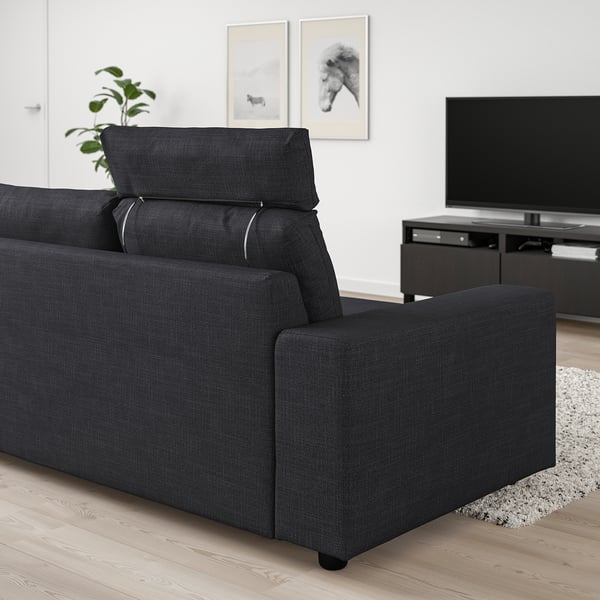 Modern black VIMLE sofa in a living room with tv and art.