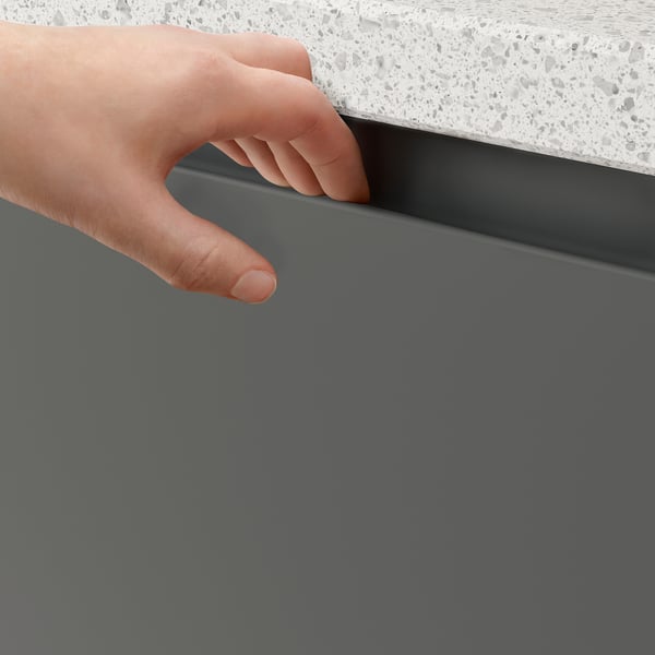 Person opening grey VOXTORP cabinet with integrated handle.