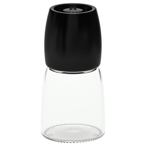 Černý mlýnek na koření IKEA s dno skleněné nádoby a keramickým vrchem.