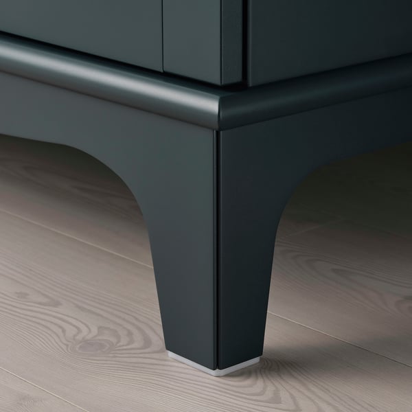 Elegantní, moderní skříňka se zúženými nohami, tmavě zelenou povrchovou úpravou, vysoce kvalitními materiály.