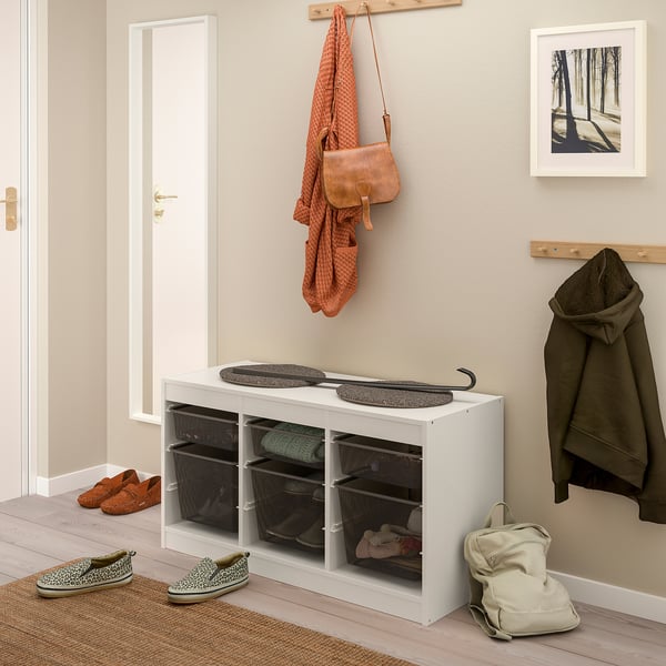 Bílá úložná jednotka TROFAST, velká, pojme košíky a předměty, pod věšákem.