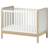 ÄLSKVÄRD white & light wood baby cot with removable side, adjustable base, and guard rail.