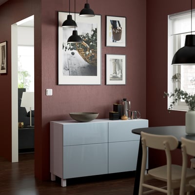 Modern kitchen with BESTÅ storage, maroon wall, plants.