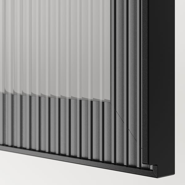 A sleek black BESTÅ storage unit with glass doors, featuring adjustable shelves and soft-close hinges.
