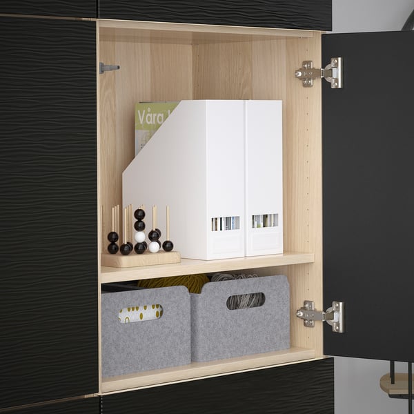 BESTÅ open wooden cabinet with adjustable shelves and decorative items.