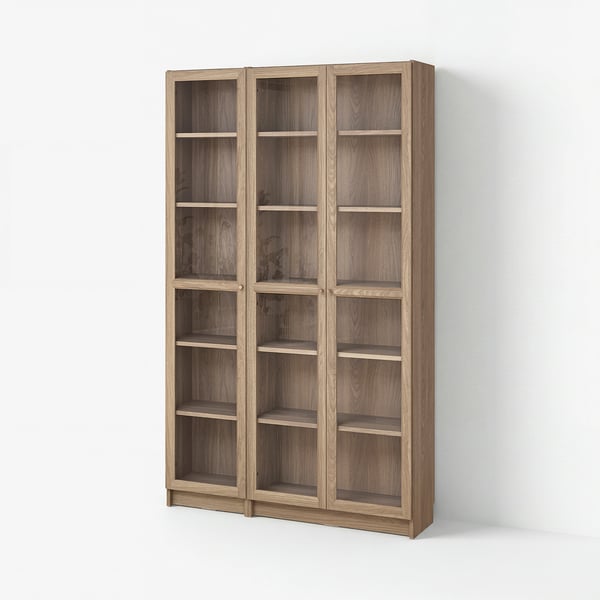 BILLY light brown wooden bookshelf with glass doors, featuring multiple shelves, against a white wall.