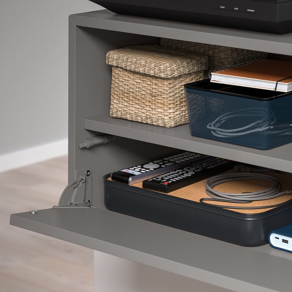 Grey EKET media shelf with flip-down front, cable management.