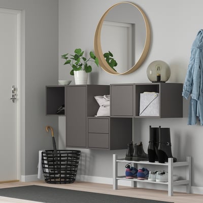 Modern entryway with EKET storage, mirror, umbrella basket, shoe rack, and blue jacket.