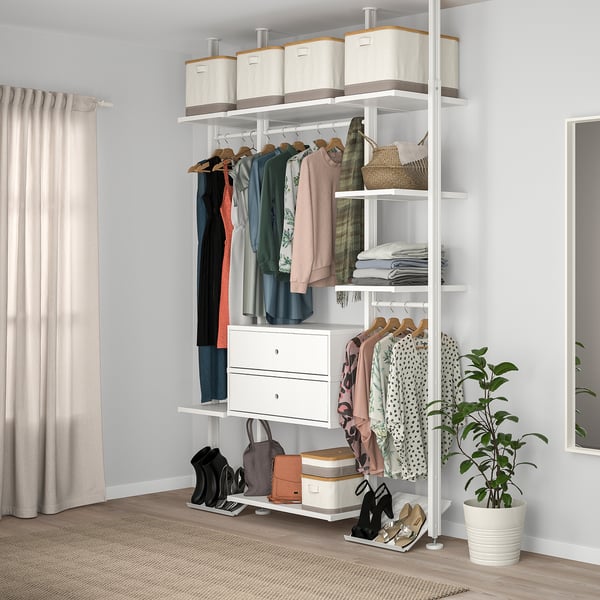 Modern closet with ELVARLI system, clothes, shelves, drawers, and plant.