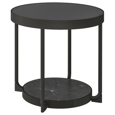 A sleek black round side table with a glass top and a marble-effect shelf, supported by four slim metal legs. Modern and minimalist design.