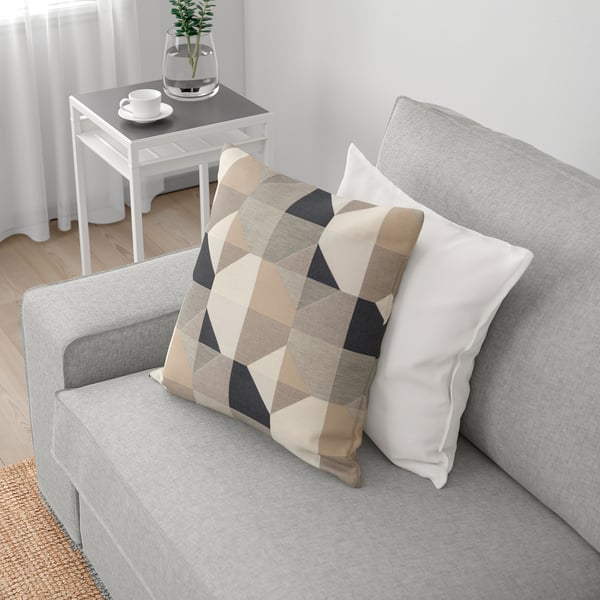 Grey KIVIK sofa with pocket spring cushions, removable armrests, and geometric pillow.