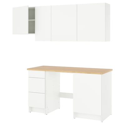 Modern white kitchen setup with wood countertop, featuring cabinets and drawers for efficient storage.