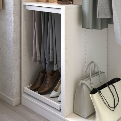 KOMPLEMENT wardrobe organiser with grey clothes and beige accessories.