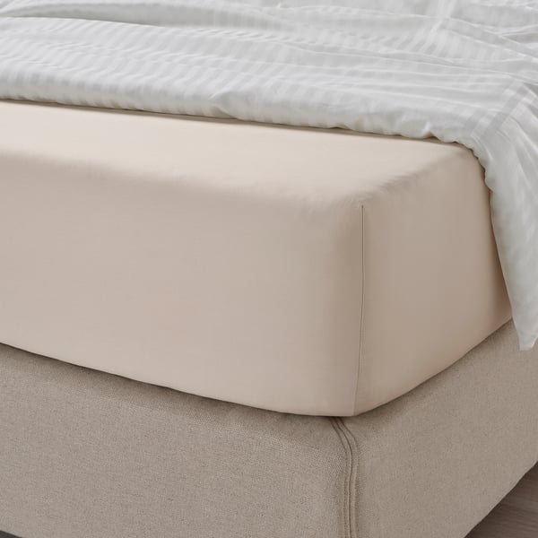 Bed sheet shown in tan, sateen-woven, fits mattresses up to 26 cm.