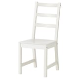 A white, wooden kitchen chair with a ladder-back design and a carved seat. Fine for dining use.