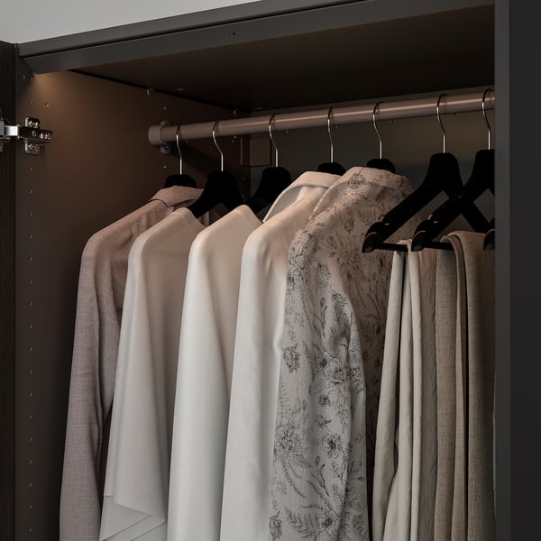 Closet with led light strips illuminating clothes on hangers.