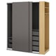An IKEA PAX wardrobe with grey sliding doors and a light wood side. It has shelves and drawers for storage, offering a sleek and organised design.