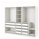 A white IKEA PAX wardrobe system, featuring shelves, drawers, and hanging space.