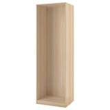 Ikea PAX wardrobe frame in light oak, upright with empty shelves.