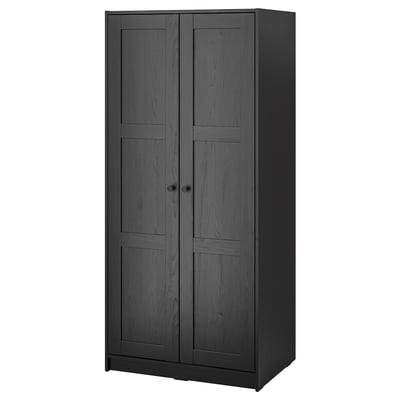 Black RAKKESTAD wardrobe with sleek design and two doors. Modern, tall, rectangular shape with wood-like fiberboard.