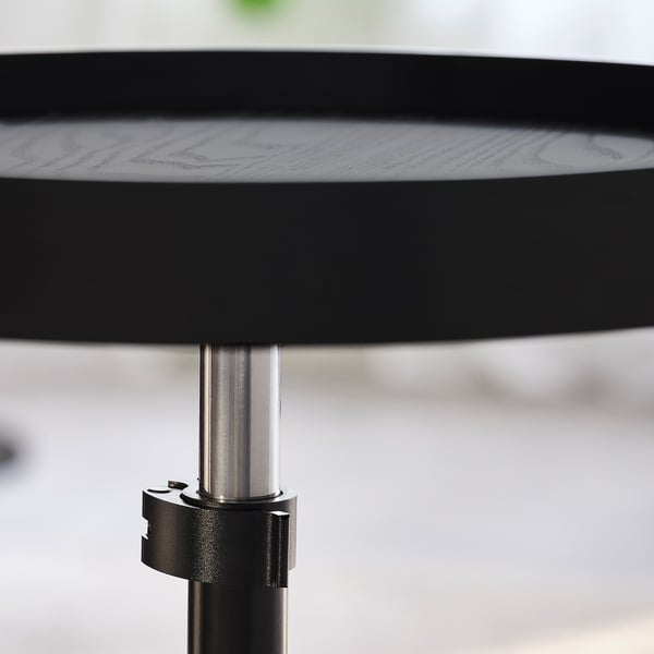 Adjustable side table with metallic stand and wooden top.