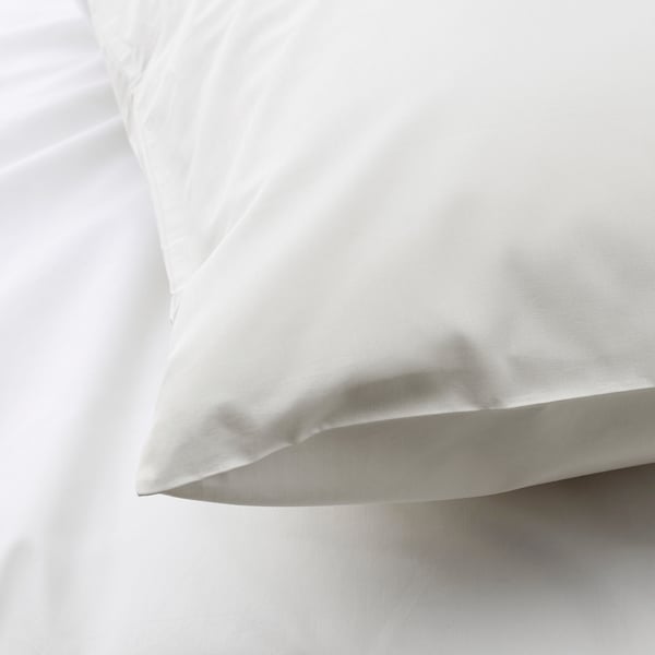 Close-up of crisp, white pillowcase with smooth, high-quality fabric.