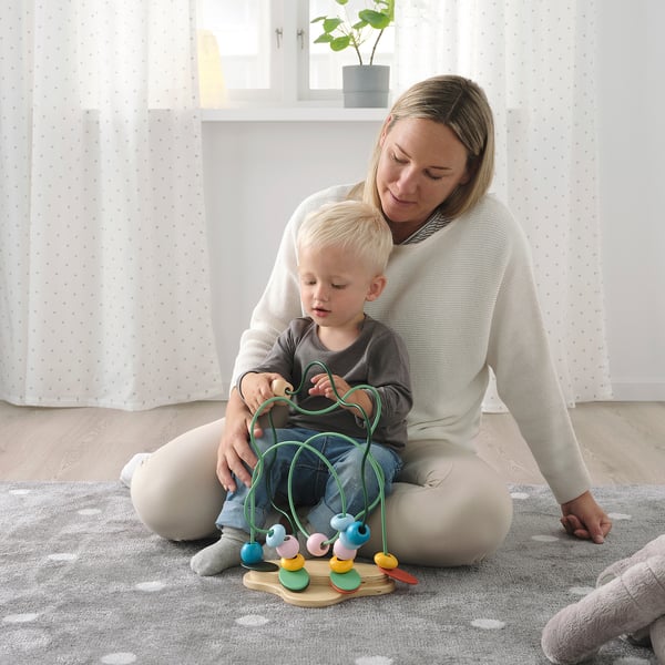 Person & child play with UPPSTÅ wooden toy, learning colours & shapes