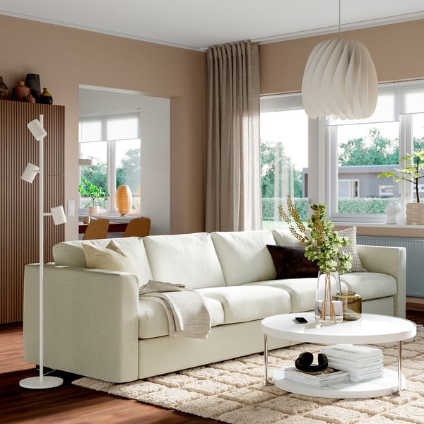 Modern living room with VIMLE sofa, coffee table, rug, and large windows with curtains.
