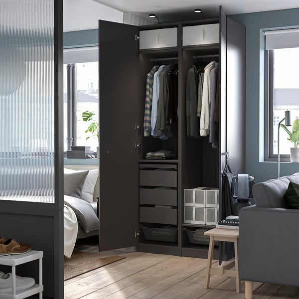 Modern bedroom with open wardrobe, featuring clothes hangers, drawers, and a black YTBERG led lamp attached to the top, providing adjustable lighting.