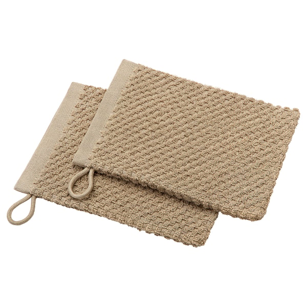 Zwei beige Baumwoll-Waschhandschuhe mit Schlaufe zum Aufhängen, ordentlich gefaltet.
